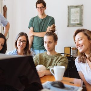 pexels photo 1595391 1595391 A diverse group of adults at work, enjoying a casual meeting indoors with focus and smiles.