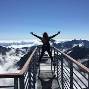 pexels photo 725255 725255 A woman stands on a viewing platform in Vysoké Tatry, Slovakia, surrounded by clouds and mountains, embracing freedom.